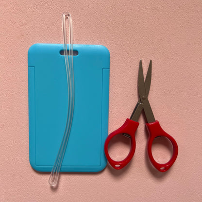 Light Blue luggage tag with travel approved scissors and luggage tag attachments. 