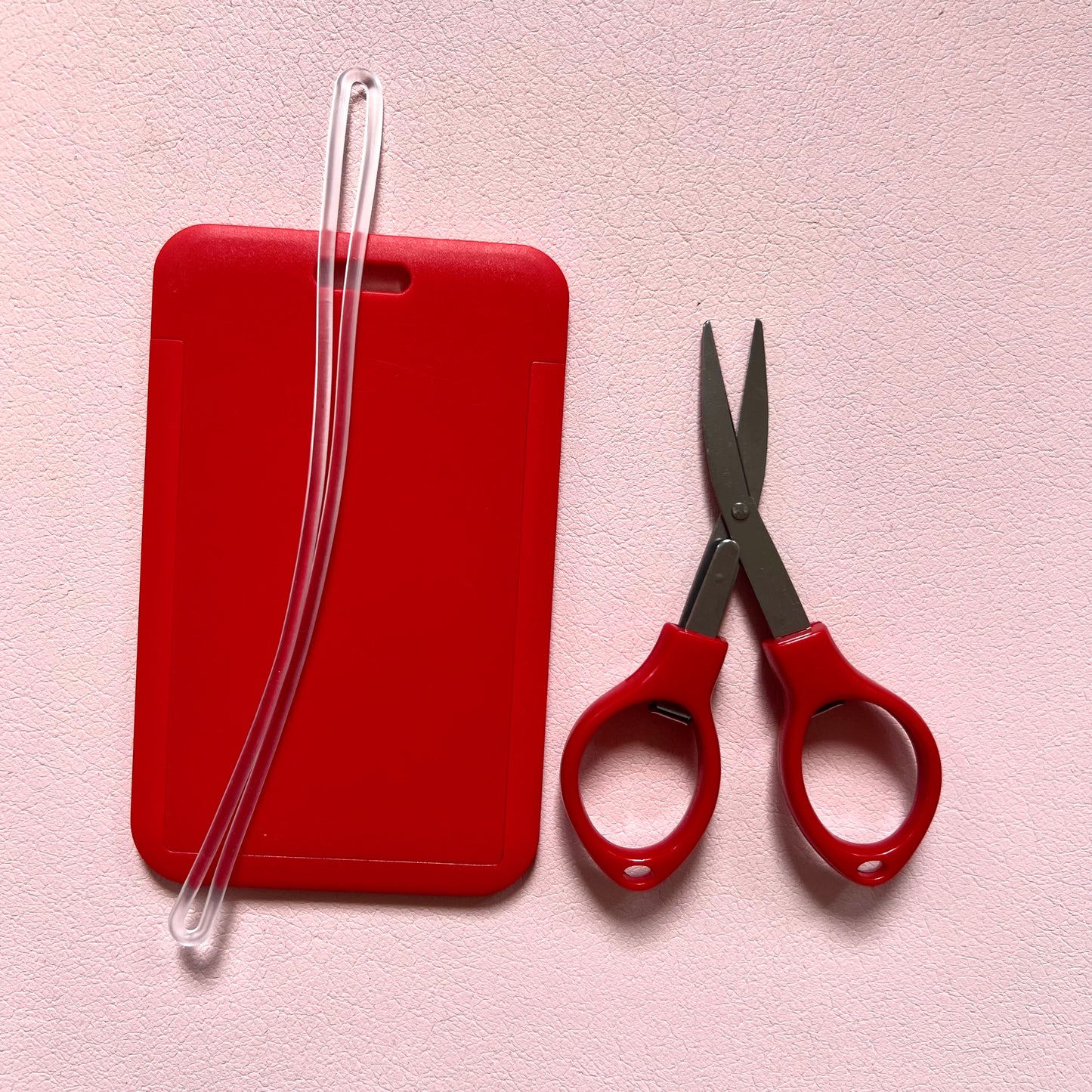 Red luggage tag with travel approved scissors and luggage tag attachment