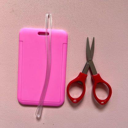 Pink luggage tag with travel approved scissors and luggage tag attachments. 